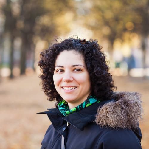 portrait-of-happy-woman-with-curly-hair-at-park-2024-10-18-04-16-23-utc.jpg