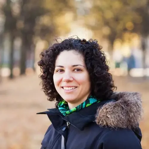 portrait-of-happy-woman-with-curly-hair-at-park-2024-10-18-04-16-23-utc.jpg